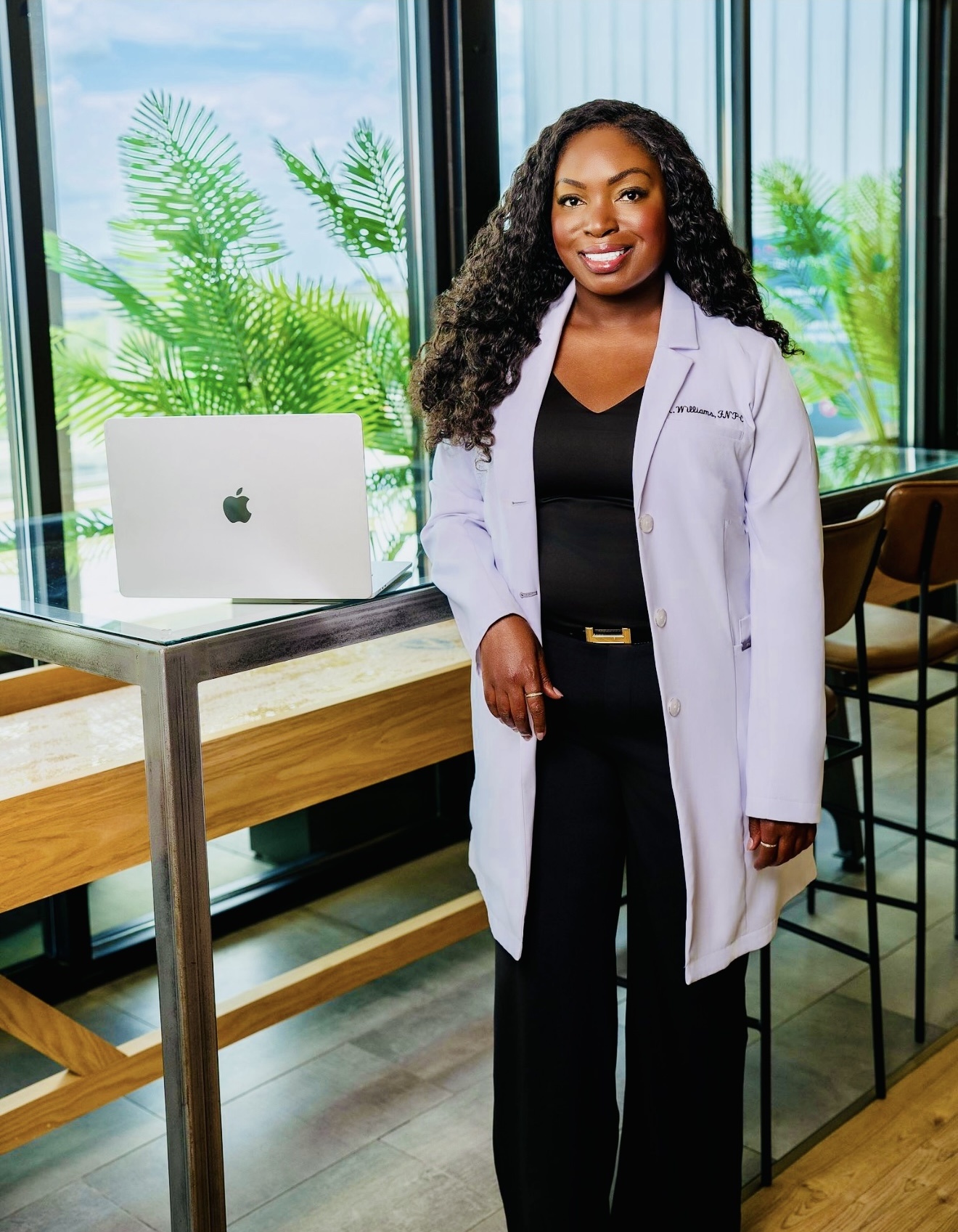 Kim Williams, MSN, APRN, FNP-C in her white coat